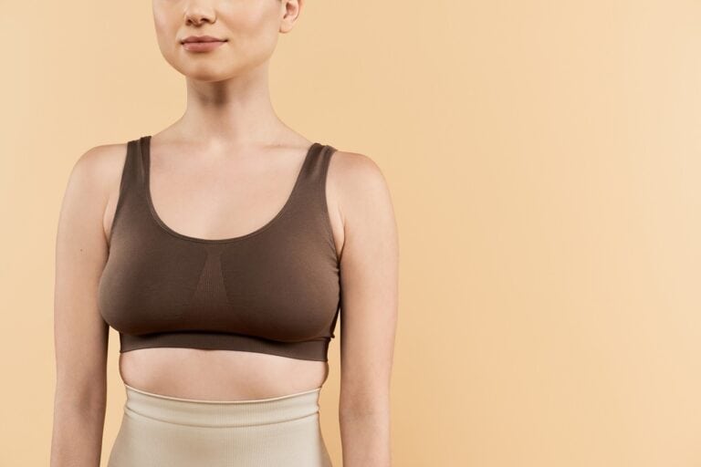 woman in compression bra posing in nude background