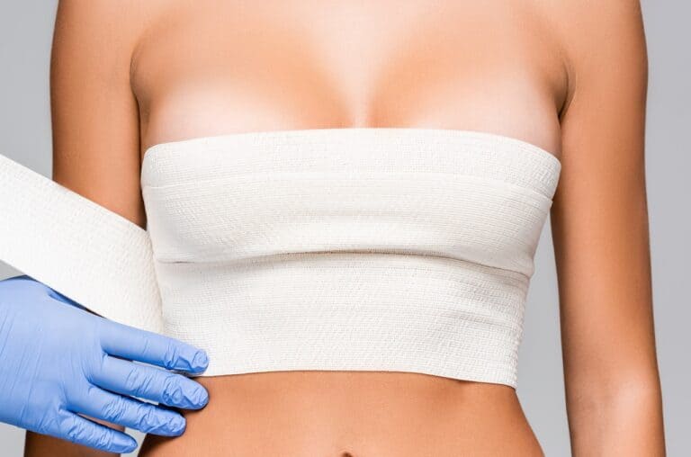 surgeon wrapping patient breast area